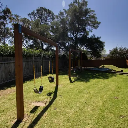 Wooden swing sets on the lawn of the church children's playground