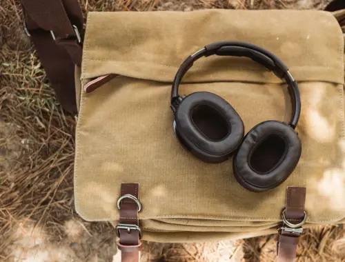 Headphones resting on a canvas satchel